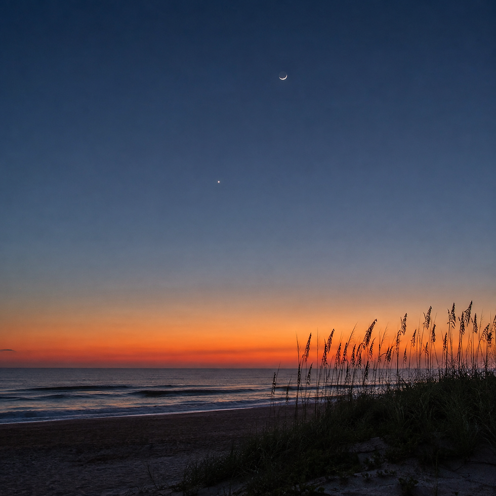 Crescent moon and bright planet over a calm ocean at sunset, with orange horizon and dune grasses in silhouette.