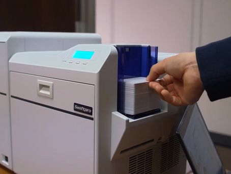 Person loading ID cards into an ID card printer