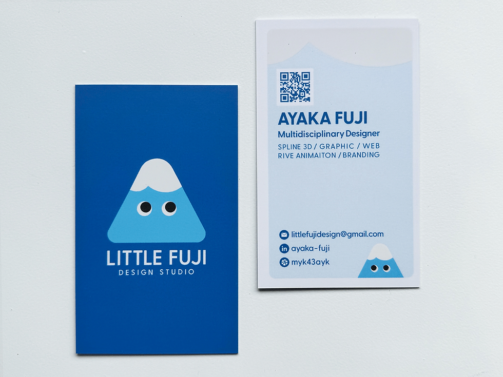 Two blue business cards on a white surface. One features a cartoon mountain and "Little Fuji Design Studio." The other shows contact info for Ayaka Fuji.