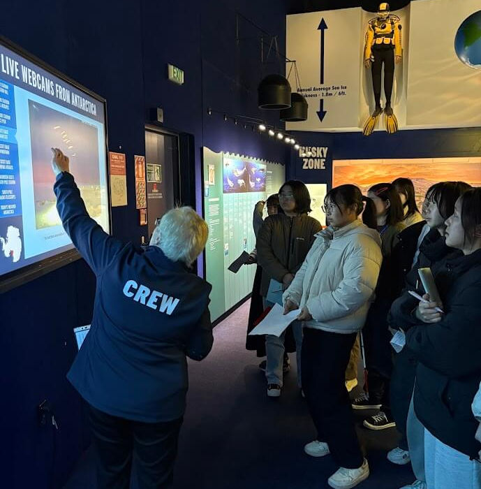 Students exploring interactive exhibits and learning about Antarctica during an educational visit in Christchurch.