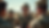Soldiers in camouflage uniforms gather in a desert setting, one speaking while others listen intently. Clear sky, focused and serious mood.