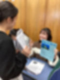 Students developing their English communication and presentation skills through interactive classroom activities and group discussions at SCLI.