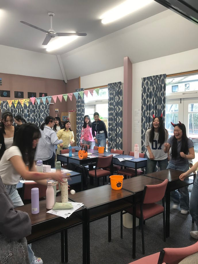 Students enjoying a fun Halloween party together through games and seasonal activities at SCLI.