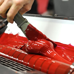 Image of red ink in ink duct on printing press