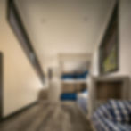 Bunk room with rustic finishes and natural light.