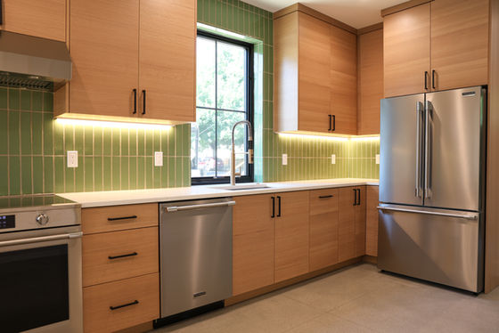 Kitchen - Interior of Joyce Park Residences showing an open living space with natural light, a modern kitchen with a peninsula, and warm wood and neutral finishes designed for everyday comfort.