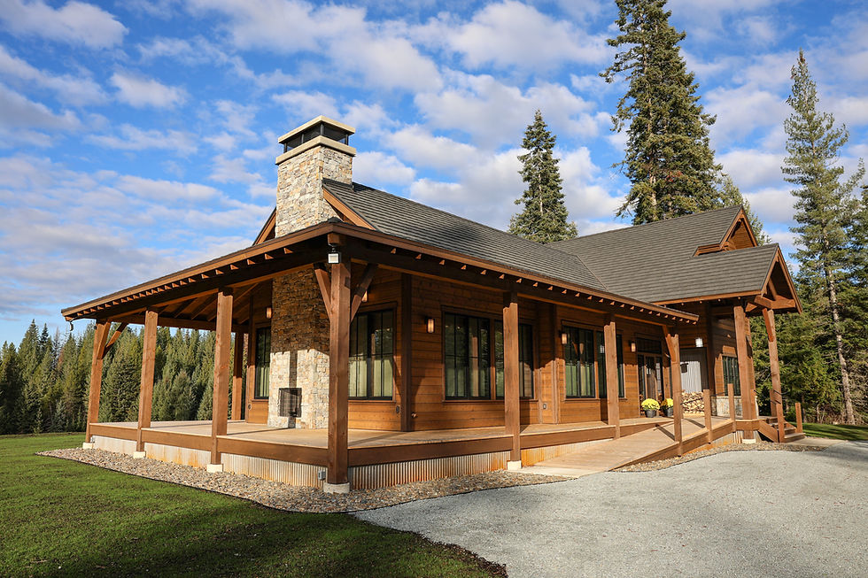 Timber-framed North Idaho custom home with natural stone accents, vaulted ceilings, large windows, a