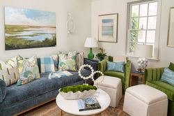Den with blue sofa, large artwork, lamps & a window