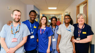 NHS Staff standing in a row smiling