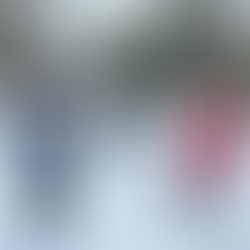 4 people dance in the snow in winter clothes.