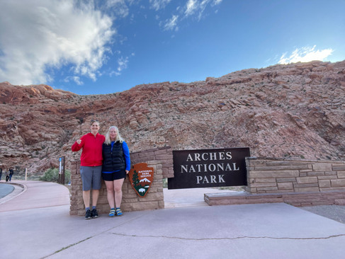 Jenny and Gina "American Gothic" at Arches sign