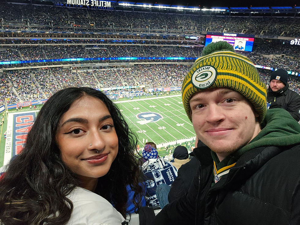 Luke and Anha take a selfie at MetLife stadium while watching a Packer game.