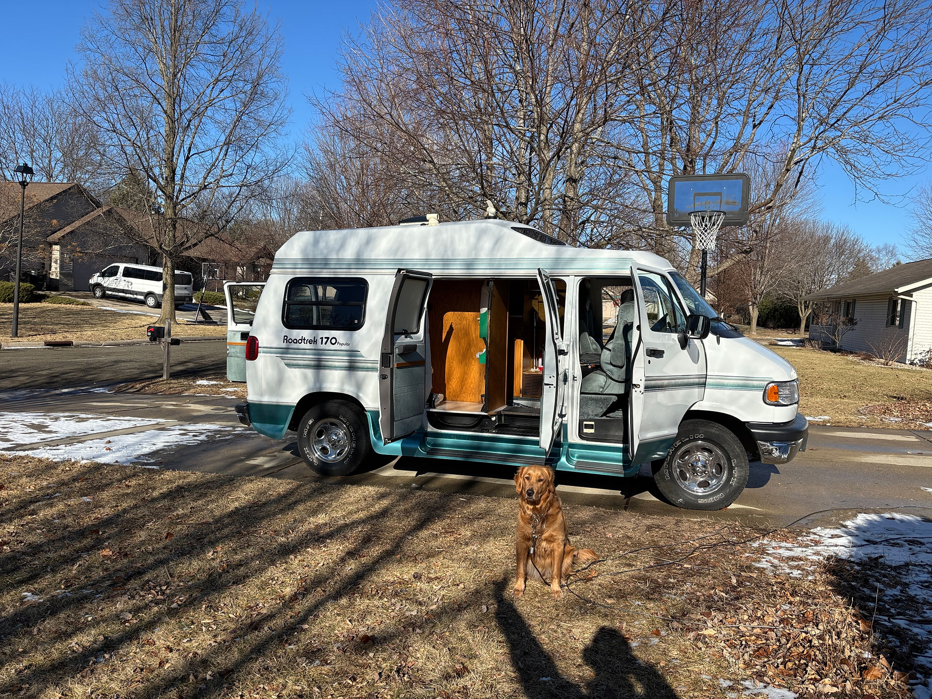 White Roadtrek 170 Popular in a driveway with the passenger side doors open