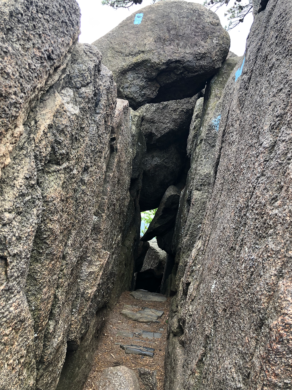 A tunnel through Old Rag Granite in Shenandoah National Park. Blue paint on the rocks show hikers the route.