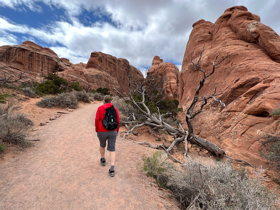 Jenny Rule hikes toward Pine Tree Arch at Arches National Park.