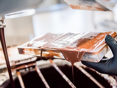 Fabrication artisanale de pralines au chocolat dans un atelier belge.