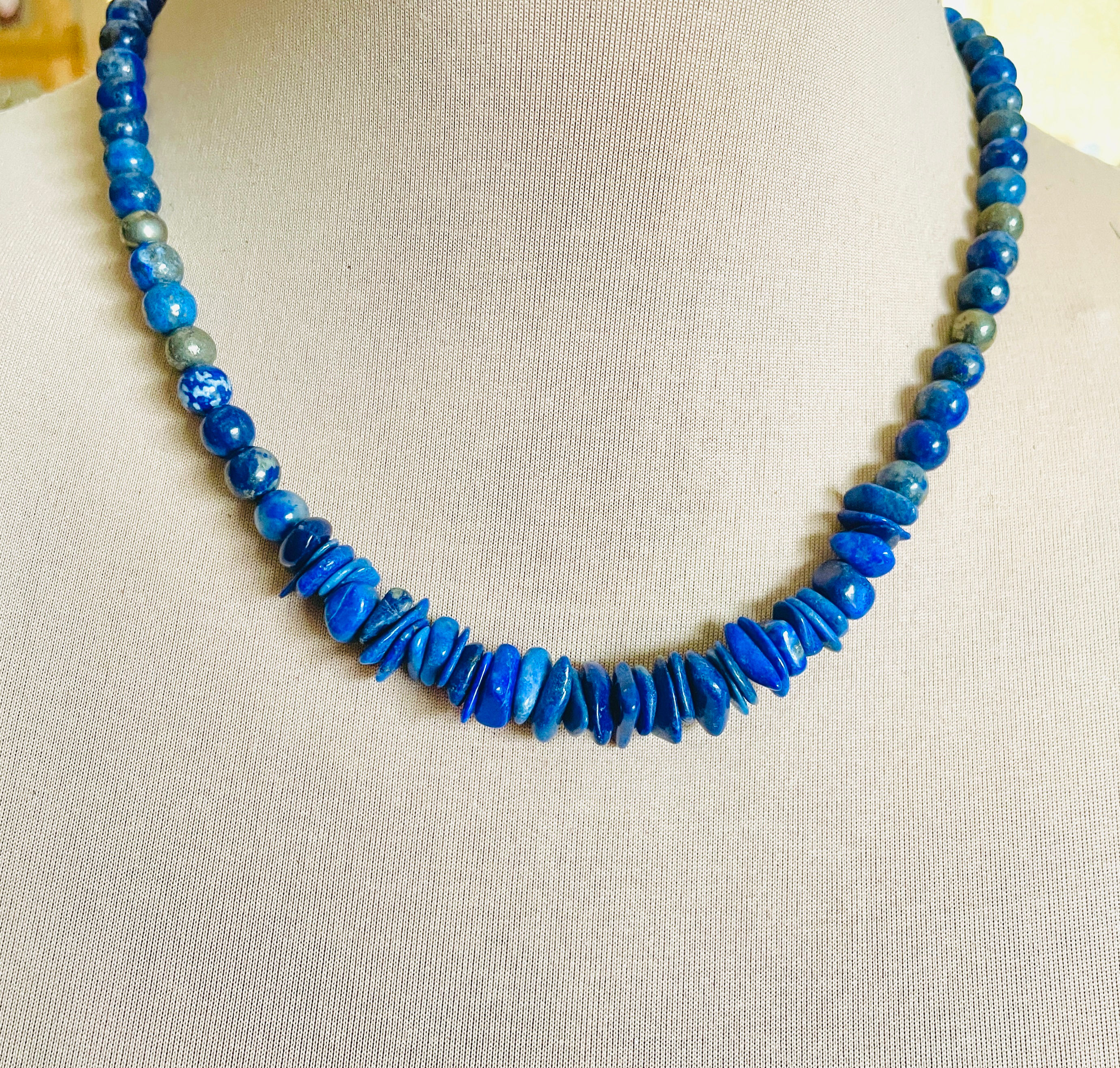 Necklace featuring deep royal blue lapis lazuli round beads, lapis chips, and metallic pyrite accents
