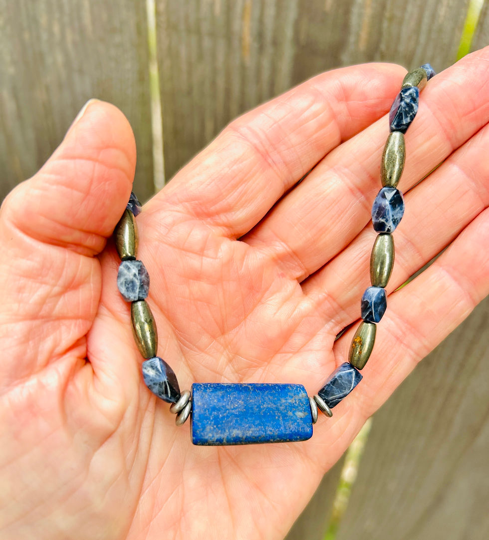 Thumbnail: lapis lazuli rectangular focal necklace with sodalite and pyrite beads held in hand