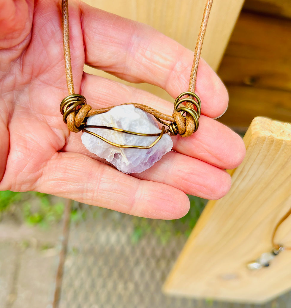 raw amethyst stone with unique horizontal wire wrap complimented with metal rings on rusty brown faux leather