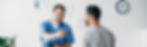 panoramic-shot-of-smiling-physiotherapist-with-diagnosis-near-patient-in-hospital.jpg