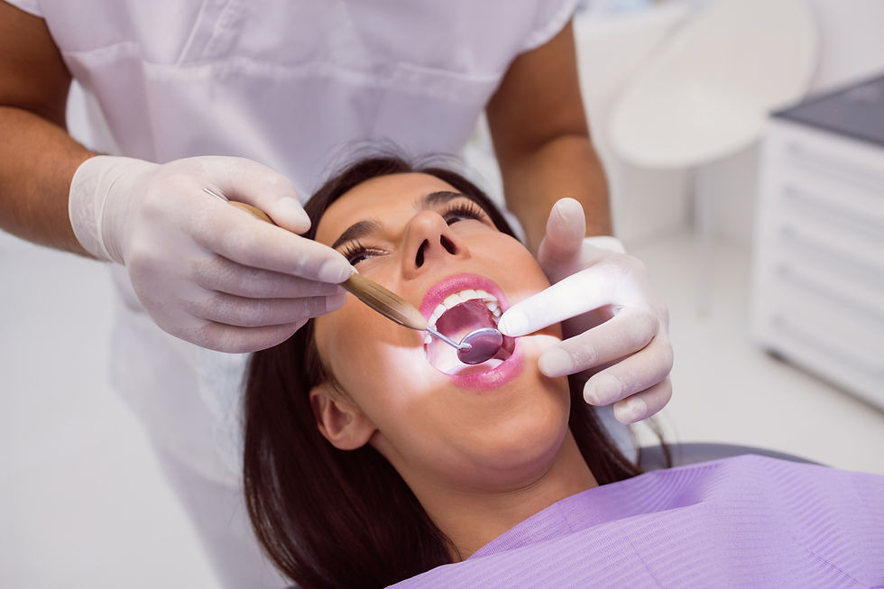 dentist-examining-patient-teeth-with-mouth-mirror.jpg