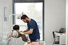 male-dentist-examining-female-patient-clinic.jpg