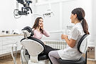 female_dentist_talking_young_patient_appointment_modern_dental_clinic (2).jpg