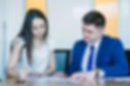 two-sitting-business-people-looking-documents.jpg