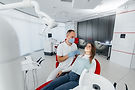 young_dentist_specialist_examines_treats_teeth_beautiful_woman_modern.jpg