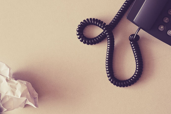 black-land-line-telephone-white-crumpled-paper.jpg