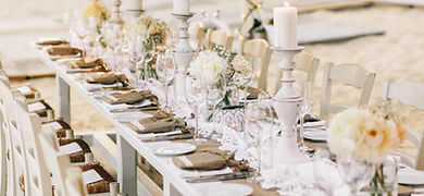 long-dinner-table-decorated-with-flaxen-cloth-white-candles.jpg