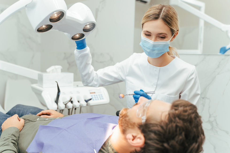 professional_woman_dentist_turning_lamp_while_preparing_checking.jpg