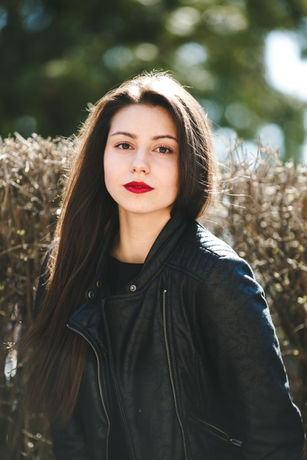 young-beautiful-girl-posing-black-leather-jacket-park