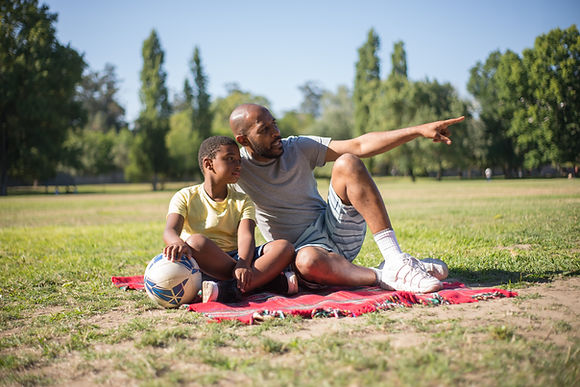 portrait_young_afro_american_man_boy_resting_ground_happy_daddy.jpg