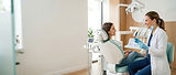 dentist_consulting_patient_modern_dental_office_examination_room.jpg