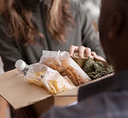 volunteer-handing-donation-box.jpg