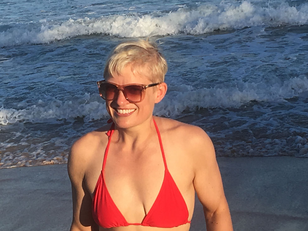 woman-smiling-red-bikini-beach-waves.jpeg