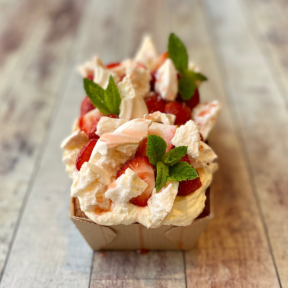 A Pimms and Elderflower soaked Sponge topped with Meringue, British Strawberries and Garden Mint