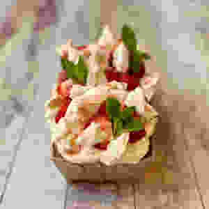 A Pimms and Elderflower soaked Sponge topped with Meringue, British Strawberries and Garden Mint