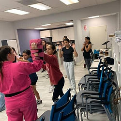 Women practicing striking drills during a Pretty Hands, Hard Punches women’s self defense empowerment workshop led by Elicia Ybarra.
