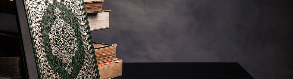 quran resting against a stack of other books