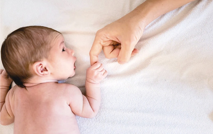 MothersEssence_Stock_BabyHoldingHand_WEB