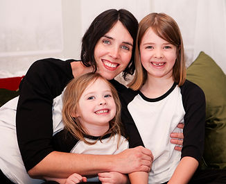 Mom smiling with her two daughters
