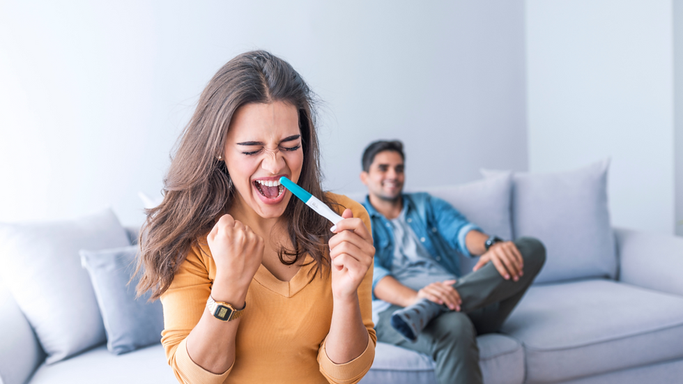 Woman excited with positive pregnancy test, man smiling