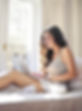 woman-in-gray-tank-top-sitting-on-bed-us