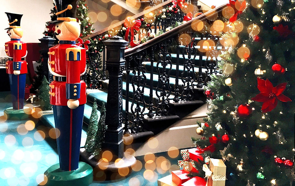 Big nutcrackers at foot of decorated main stairfcase and Christmas trees at Treasury Buildings Melbourne