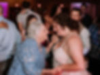 Bride dancing with a loved one during a joyful wedding reception celebration.