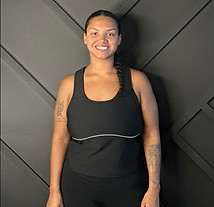 Pilates and barre instructor Caitlin Burgess standing in black activewear, teaching group fitness in Destin, 30A, Crestview, and Milton Florida