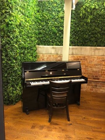 black upright piano in studio