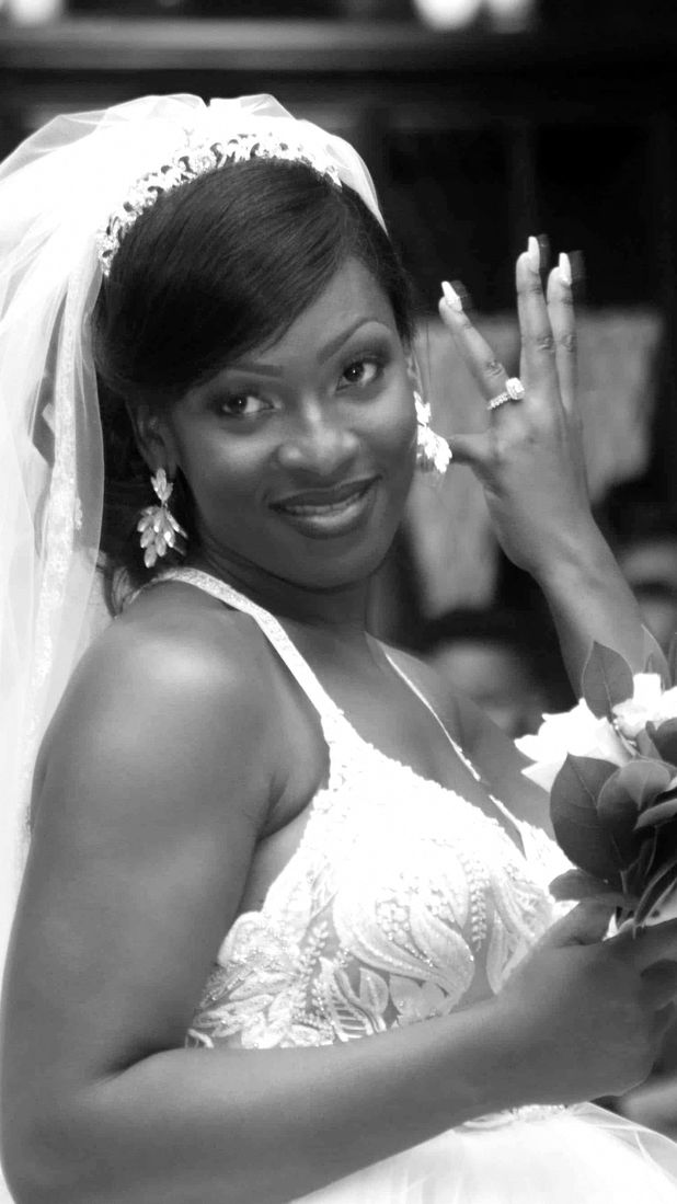 A beautiful bride in a white wedding dress holding a bouquet of flowers and ring